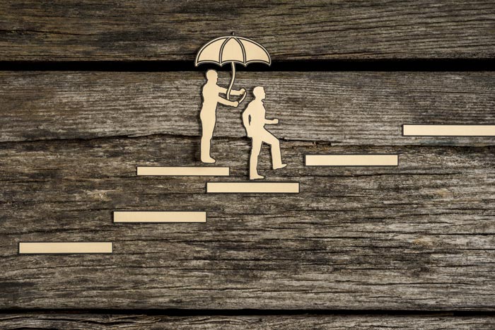 person holding umbrella over other person climbing stairs