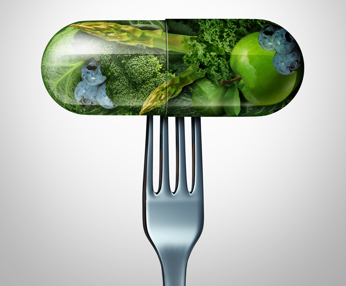 illustration of fork holding a capsule containing leafy greens, apples and blueberries - deficiencies