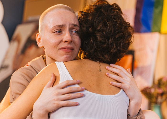 women hugging crying shame guilt recovery addiction