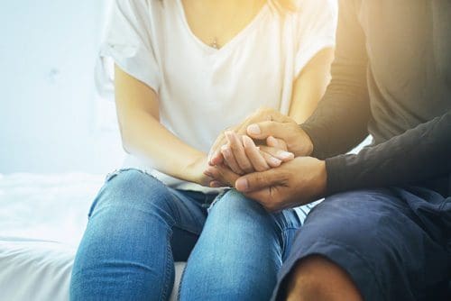 Two people holding hands.