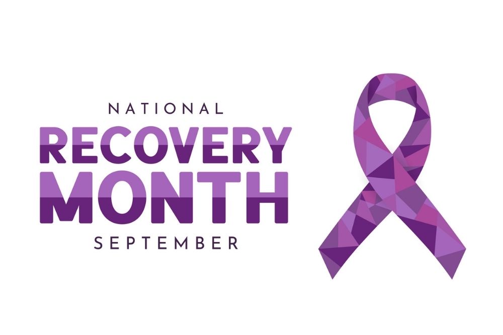 Purple geometric ribbon with text reading ‘National Recovery Month September.’